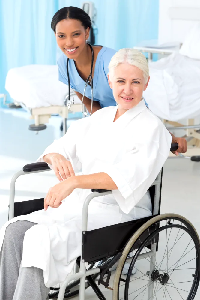 nurse and aged woman smillig at camera
