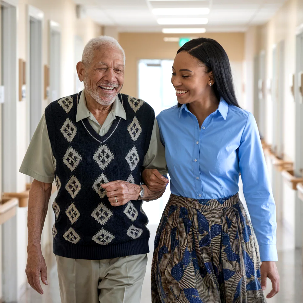 young woman assiting aged man while walking and smiling